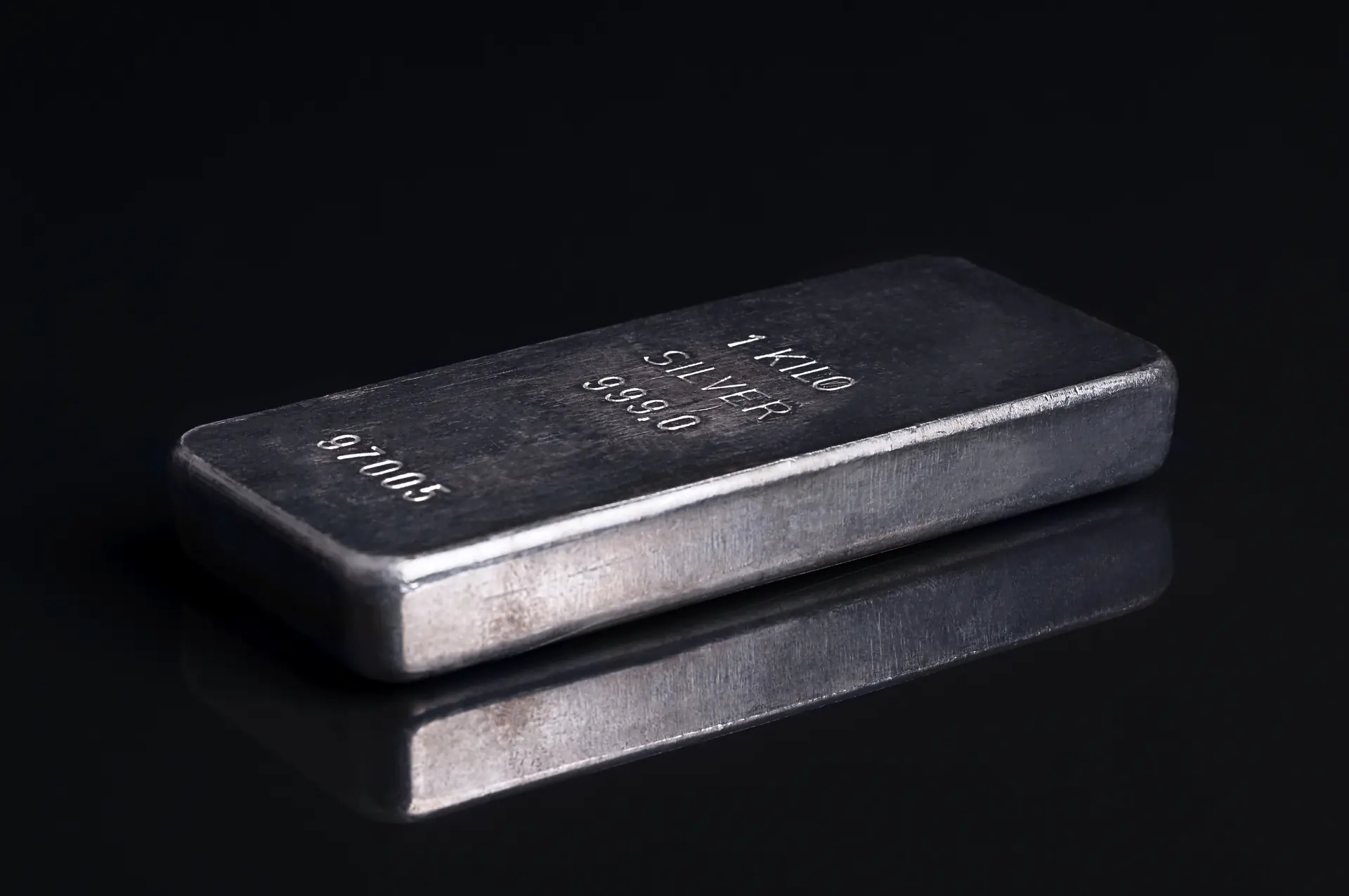 Cast 1 kilo silver bar stamped 999.0 on a black surface