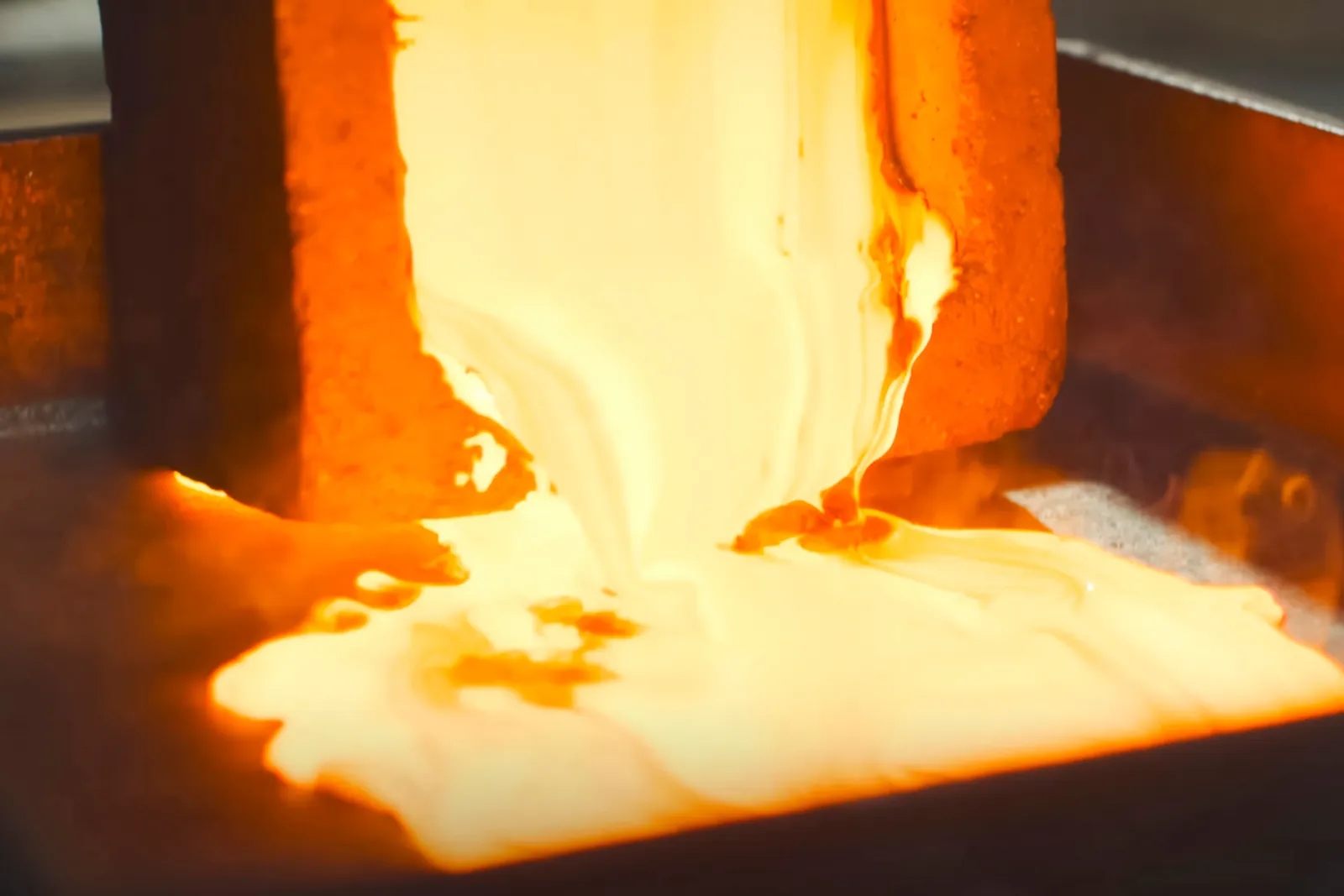 Molten gold being poured at a refinery