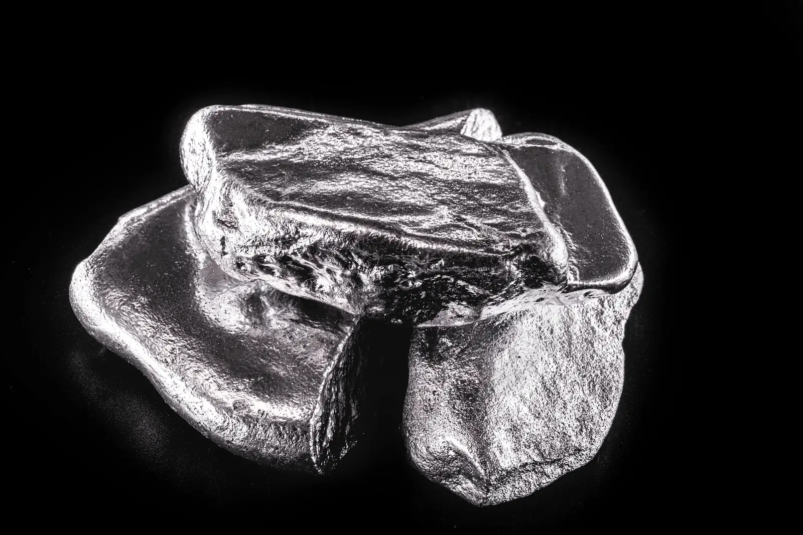 Piece of rhodium metal on a black background